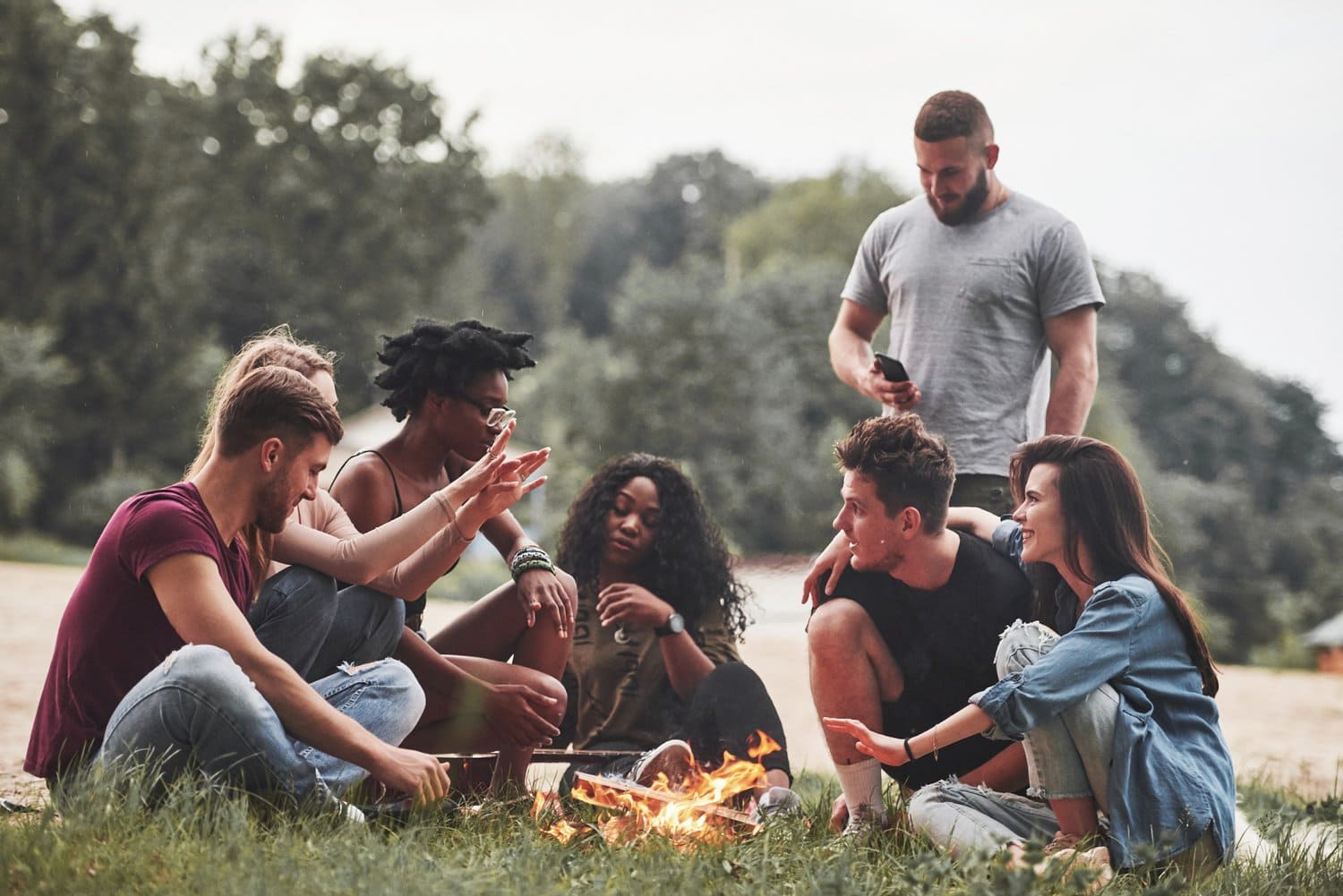 a group of friends bonding around a bon fire